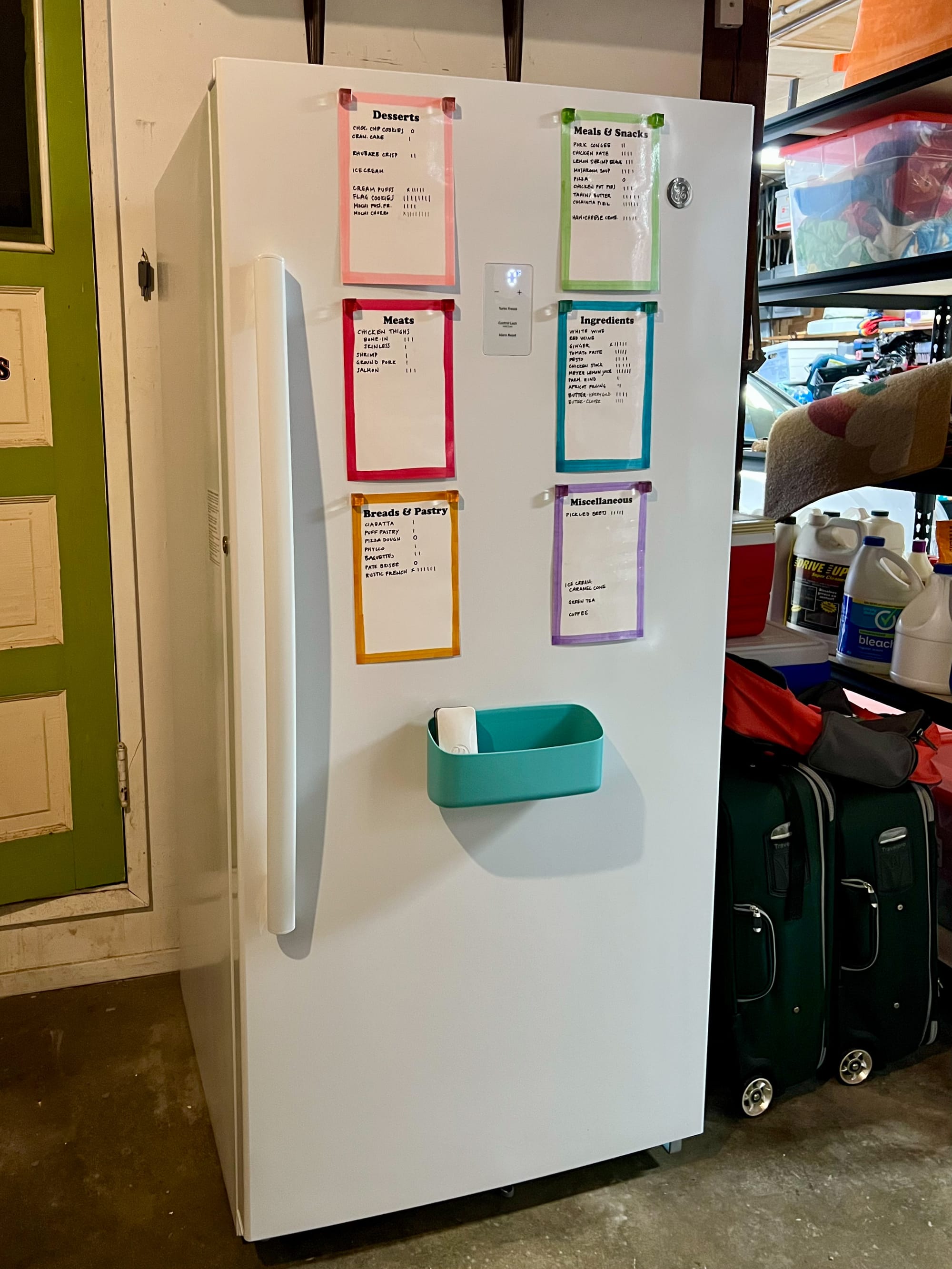 A white upright freezer, about 5 feet tall. There are six mini whiteboards and a small magnetic tray on the front.