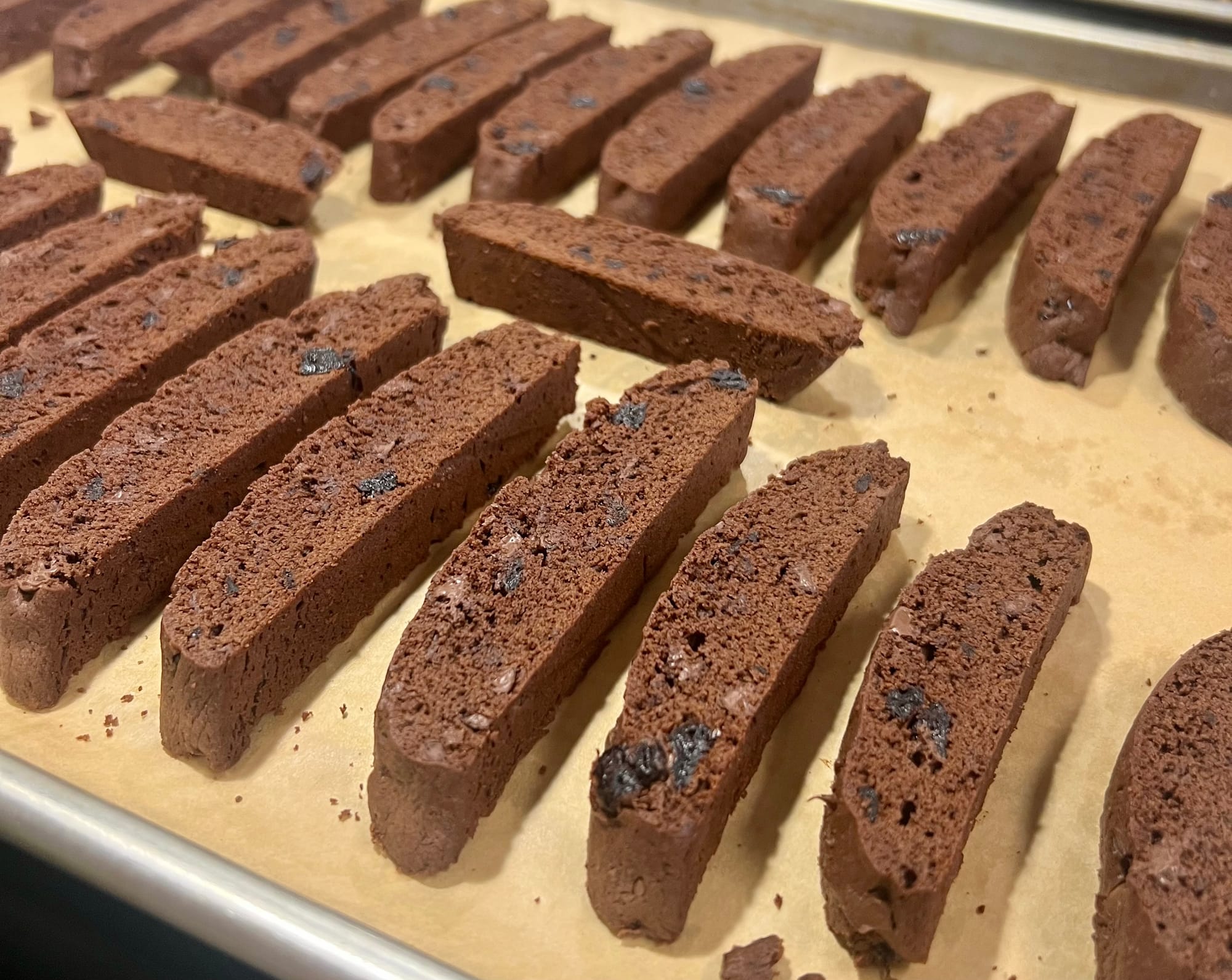 The slices are arranged on a baking sheet, on their sides, with about 1/4" space between them, for their second bake.