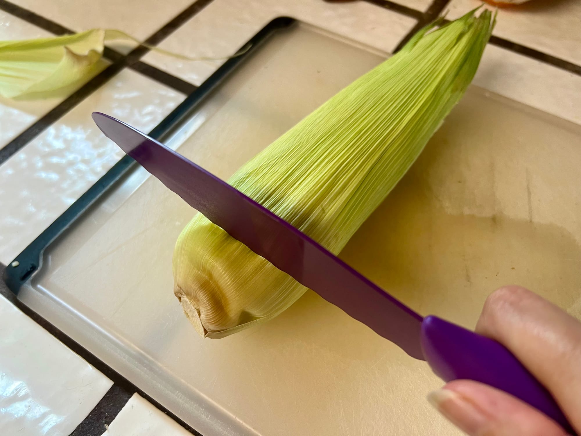 Cut the corn at its base, about an inch up from the stem.