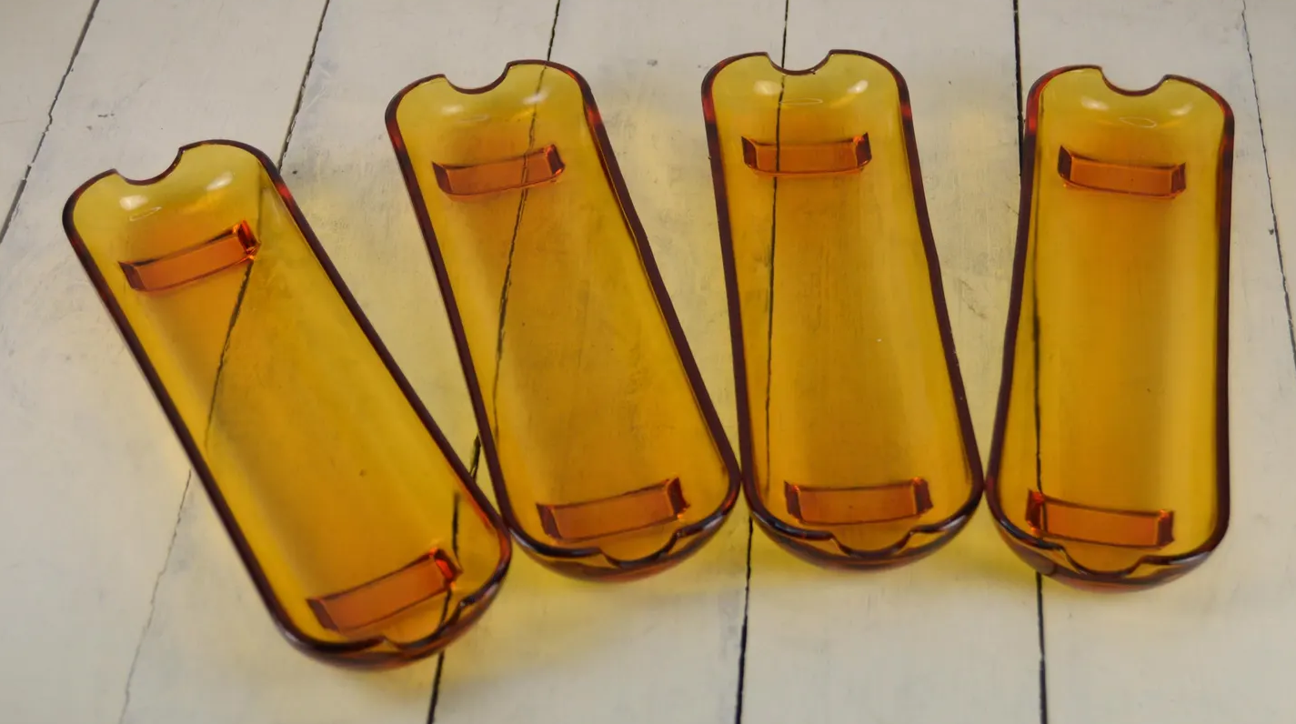 Four long, narrow glass bowls, just the right size to hold corn on the cob.